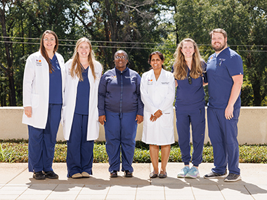 Outdoor group picture of two instructors and four fellows.